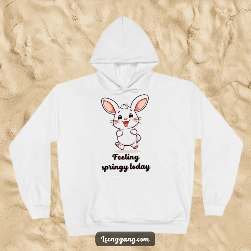 Funny hoodie featuring a smiling bunny with oversized ears, captured mid-hop in a moment of pure delight and happiness.