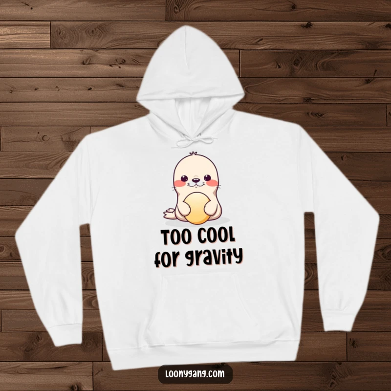 Funny Hoodie print of a playful seal attempting to balance a ball on its nose, looking endearingly unstable and happy.