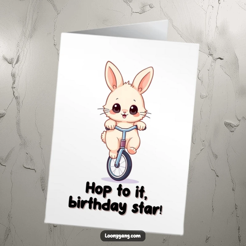 Funny Free Printable Happy Birthday card featuring a fluffy rabbit with wide eyes playfully balancing on a unicycle.