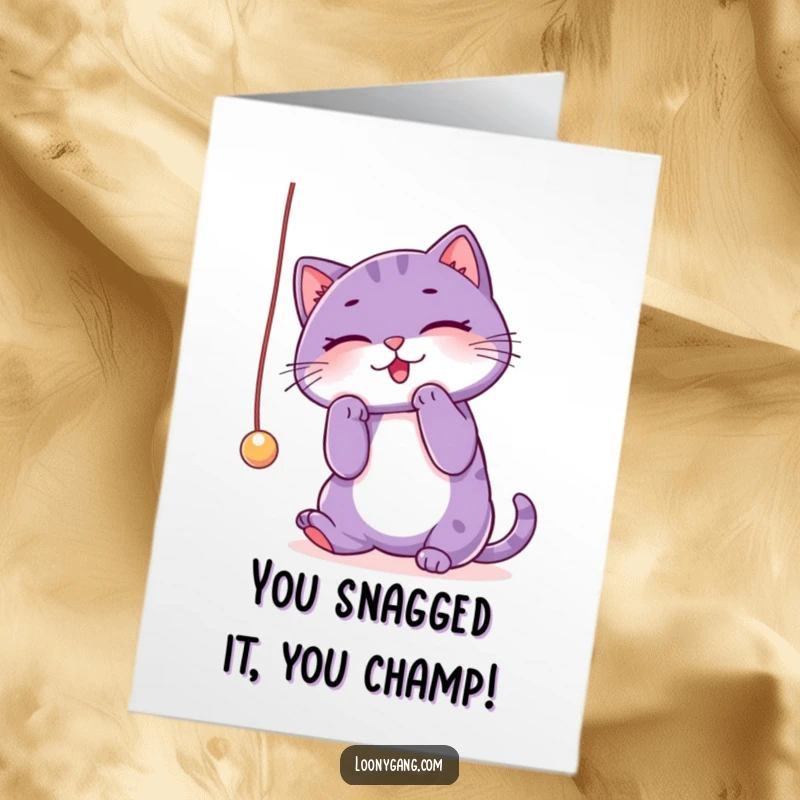 Funny Free Printable Congratulations Card: Purple cat focused on a dangling string, celebrating success.