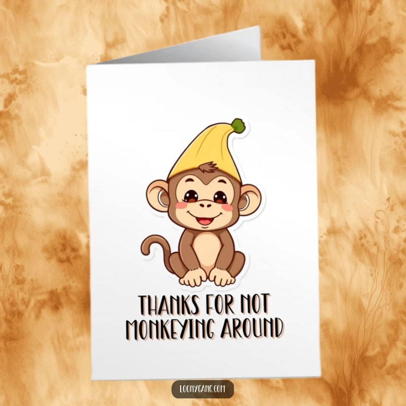 Funny free printable thank you card showing a silly monkey wearing a banana peel as a hat with a cheerful grin.