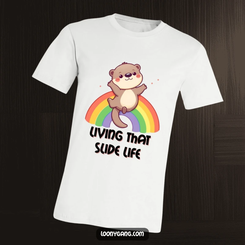Funny otter t-shirt featuring a playful otter sliding down a rainbow, symbolizing joy and carefree fun.