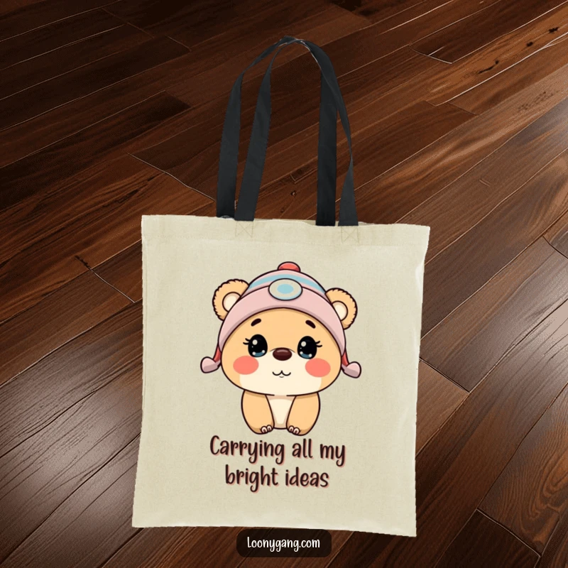 Funny bear cub wearing a propeller beanie, eyes wide with surprise, on a durable and stylish tote bag.